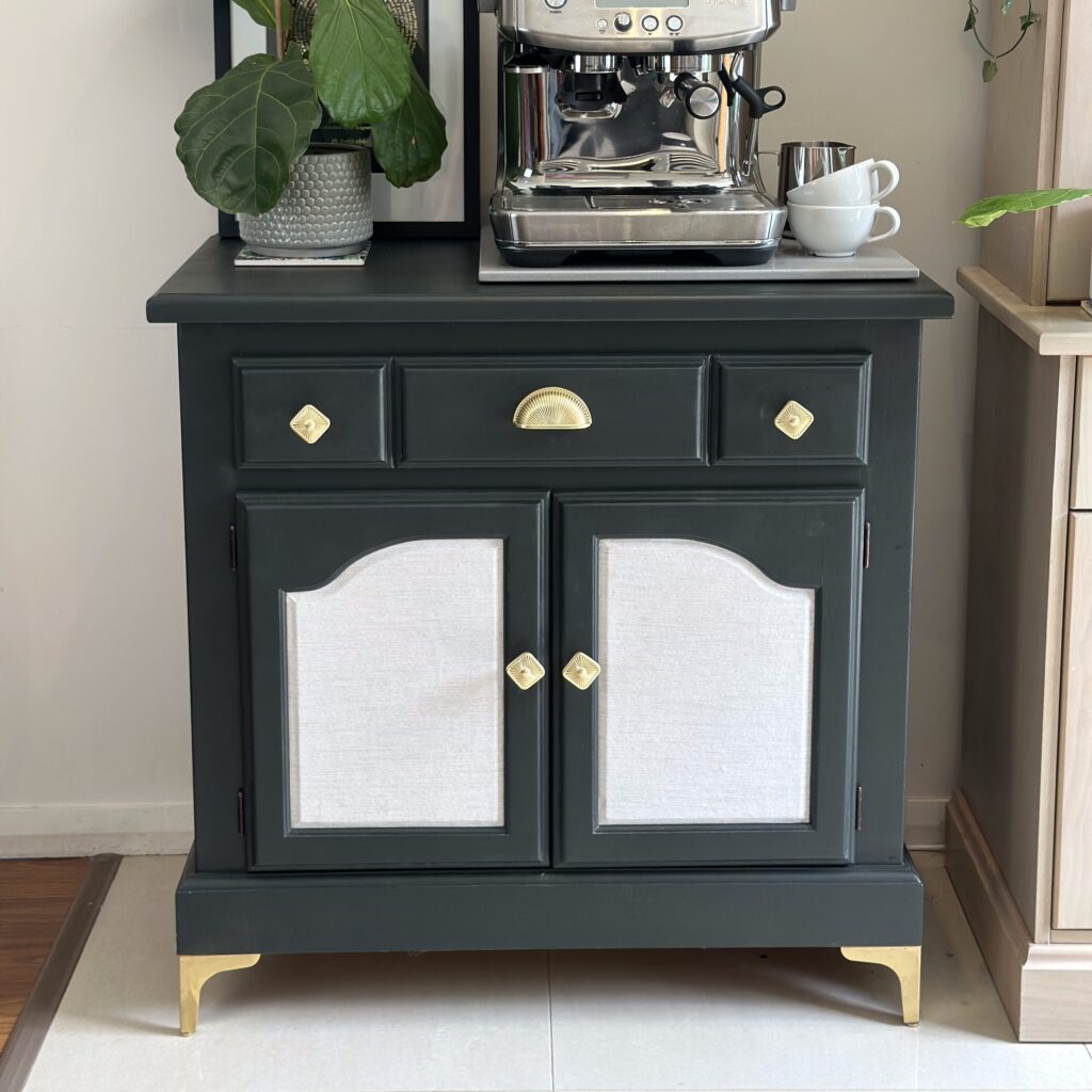 Refinished vintage sideboard painted dark green with gold hardware and updated legs, styled as a coffee bar.